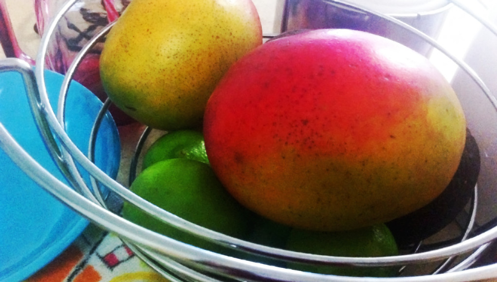 mangos about in a silver fruit bowl